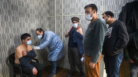 A medical worker administers Covid-19 vaccine doses to Jammu and Kashmir police personnel, at the Police Control Room (PCR). (PTI) A medical worker administers Covid-19 vaccine doses to Jammu and Kashmir police personnel, at the Police Control Room (PCR). (PTI)