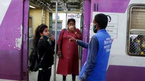 A municipal worker penalises commuters for not wearing face masks at Chhatrapati Shivaji Maharaj Terminus in Mumbai on Saturday. (AP) A municipal worker penalises commuters for not wearing face masks at Chhatrapati Shivaji Maharaj Terminus in Mumbai on Saturday. (AP)