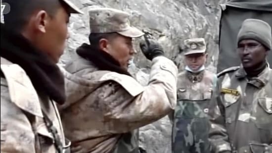 In this image taken from video footage run on February 19, 2021 by China's CCTV via AP Video, PLA regimental commander Qi Fabao (left) talks with members of the Indian military as Indian and Chinese troops face off in the Galwan Valley on the disputed border between China and India, on June 15, 2020. (AP)