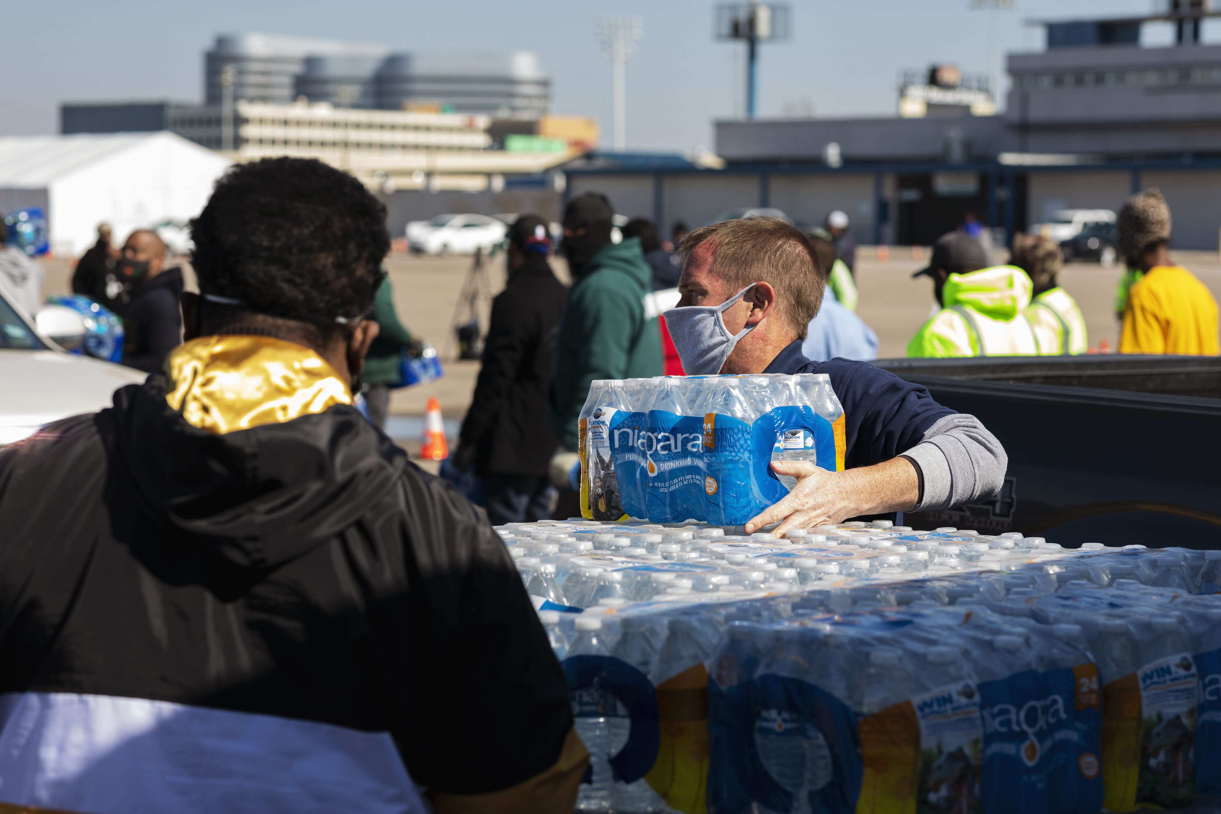 City workers and volunteers distribute bottled water at Delmar Stadium, in Houston, Texas, U.S., on Wednesday, Feb. 19, 2021. (Bloomberg)
