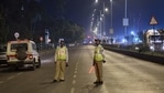Police officers maintain vigil at Marine Drive during the night curfew in Mumbai.(PTI) Police officers maintain vigil at Marine Drive during the night curfew in Mumbai.(PTI)