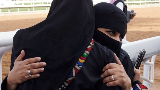 Saudi women celebrate after their horse won the first place during one of the Saudi cup competitions, at King Abdul Aziz race track in Riyadh, Saudi Arabia, Friday, Feb.19, 2021. The Saudi Cup carries a total prize purse of $30.5 million and considered the world's richest horse race which attracted some of the world's best male and female jockeys. (AP Photo/Amr Nabil)(AP)