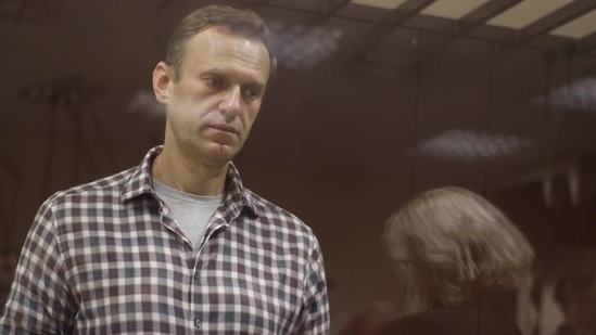 Kremlin critic Alexei Navalny, who is accused of slandering a Russian World War Two veteran, stands inside a defendant dock during a court hearing in Moscow, Russia. (Reuters)