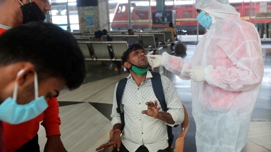 A health worker takes a swab sample of a passenger at Bandra train station in Mumbai, India, Wednesday, Feb. 17, 2021. Health officials have detected a spike in COVID-19 cases in several pockets of Maharashtra state, including in Mumbai, the country's financial capital. (AP Photo/Rafiq Maqbool)(AP) A health worker takes a swab sample of a passenger at Bandra train station in Mumbai, India, Wednesday, Feb. 17, 2021. Health officials have detected a spike in COVID-19 cases in several pockets of Maharashtra state, including in Mumbai, the country's financial capital. (AP Photo/Rafiq Maqbool)(AP)