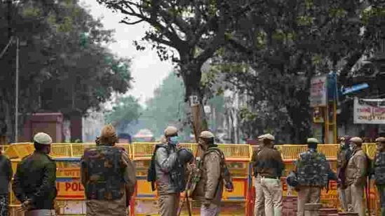 Delhi Police personnel stand guard during a protest by members of Vishwa Hindu Parishad (VHP) and Bajrang Dal over the demolition of a Hanuman temple, at Chandni Chowk, in New Delhi. (Sanchit Khanna/HT Photo)