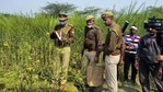 Police personnel investigate the site where bodies of two minor Dalit girls were found and another in critical condition on Wednesday evening near Baburaha village in Uttar Pradesh's Unnao district. (HT_PRINT) Police personnel investigate the site where bodies of two minor Dalit girls were found and another in critical condition on Wednesday evening near Baburaha village in Uttar Pradesh's Unnao district. (HT_PRINT)