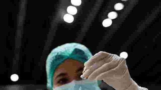 A healthcare worker prepares a dose of Sinovac's vaccine for the coronavirus disease (COVID-19) during a mass vaccination for medical workers at the Istora Senayan stadium in Jakarta, Indonesia. REUTERS/Willy Kurniawan