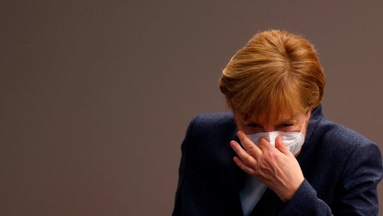 German Chancellor Angela Merkel puts her face protection mask on after a session of the Bundestag (lower house of parliament) in Berlin, amid the coronavirus Covid-19 pandemic,(AFP)