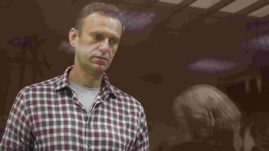 Kremlin critic Alexei Navalny, who is accused of slandering a Russian World War Two veteran, stands inside a defendant dock during a court hearing in Moscow, Russia.(Reuters) Kremlin critic Alexei Navalny, who is accused of slandering a Russian World War Two veteran, stands inside a defendant dock during a court hearing in Moscow, Russia.(Reuters)