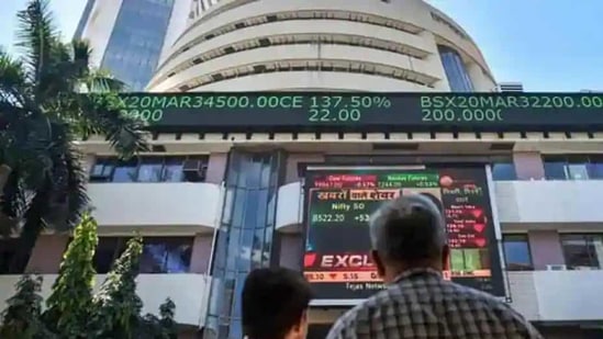 People watch the Sensex on a screen outside Bombay Stock Exchange (BSE) in Mumbai. (PTI File Photo)