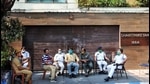 Security personnel sit outside TMC MP Abhishek Banerjee's residence, in Kolkata. (PTI)