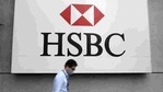 A man wearing a protective mask walks past a logo of HSBC at its headquarters.(Reuters) A man wearing a protective mask walks past a logo of HSBC at its headquarters.(Reuters)