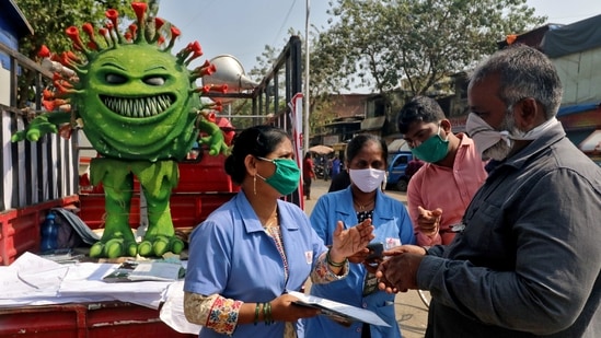 Volunteers distributing pamphlets during an awareness campaign on the spread of the coronavirus disease (COVID-19) on a street in Mumbai on February 22. With India’s active Covid-19 caseload witnessing a rise over the last week, the Centre on February 21 wrote to states and Union territories advising them to step up measures to contain the spread of the virus at the earliest.(Niharika Kulkarni / REUTERS)