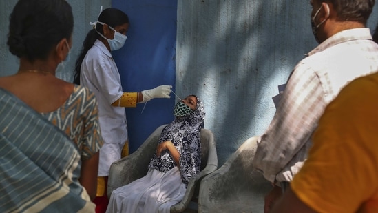 A health worker takes a nasal swab sample at a Covd-19 testing center in Hyderabad on February 23. Of the 11,046,434 positive cases logged in the country as on February 23, active cases of infection have increased marginally since the centre's instructions to 147,306, accounting for 1.34% of the total confirmed cases.(Mahesh Kumar A. / AP)
