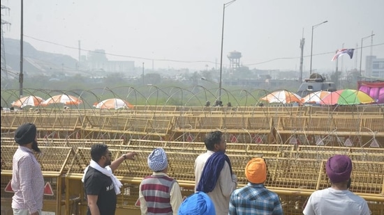 Demonstrators near police barricading at the Ghazipur border protest site as the agitation against new farm laws continues, in New Delhi, on Monday. (Sakib Ali/HT Photo) Demonstrators near police barricading at the Ghazipur border protest site as the agitation against new farm laws continues, in New Delhi, on Monday. (Sakib Ali/HT Photo)