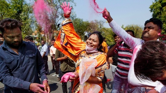 BJP workers and supporters celebrate after the party won civic body election, outside a counting station in Ahmedabad on Tuesday.(PTI Photo)