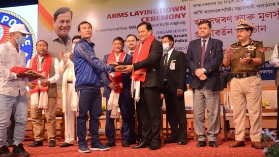 Chief of militant outfit Peoples’ Democratic Council of Karbi Longri (PDCK) IK Songbijit (in blue jacket) handing over arms to Assam Chief Minister Sarbananda Sonowal at a ceremony in Guwahati on Tuesday(HT PHOTO) Chief of militant outfit Peoples’ Democratic Council of Karbi Longri (PDCK) IK Songbijit (in blue jacket) handing over arms to Assam Chief Minister Sarbananda Sonowal at a ceremony in Guwahati on Tuesday(HT PHOTO)