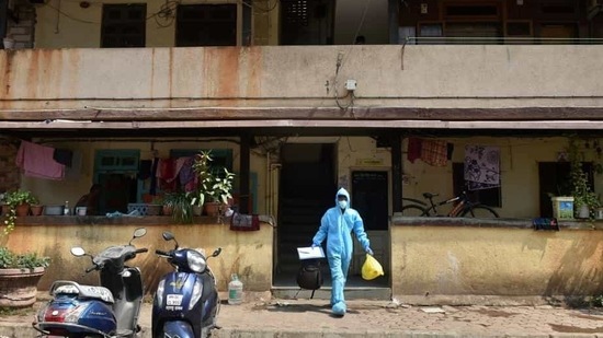 A health worker leaves a residential area after conducting swab tests for Covid-19.(PTI) A health worker leaves a residential area after conducting swab tests for Covid-19.(PTI)