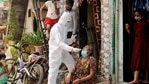 A BMC health worker wearing protective gear takes a swab sample of a woman for the Covid-19 test at Dharavi, in Mumbai on Tuesday. (ANI Photo) A BMC health worker wearing protective gear takes a swab sample of a woman for the Covid-19 test at Dharavi, in Mumbai on Tuesday. (ANI Photo)