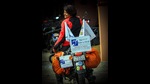 Bangalorean Bon her bike that has a sign board reading: Rider is deaf. Bangalorean Bon her bike that has a sign board reading: Rider is deaf.