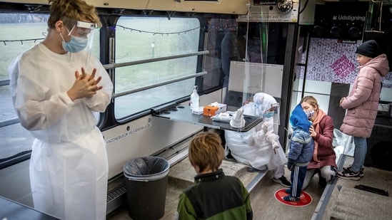 People stand in the Partybus, where people can listen to music while being tested for the coronavirus disease (COVID-19), in Ishoej, Denmark February 23, 2021. Ritzau Scanpix/Mads Claus Rasmussen via REUTERS ATTENTION EDITORS - THIS IMAGE WAS PROVIDED BY A THIRD PARTY. DENMARK OUT. NO COMMERCIAL OR EDITORIAL SALES IN DENMARK.(via REUTERS)