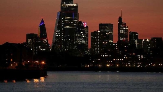 The sun sets over the skyscrapers of the City of London financial district, amid the coronavirus disease (Covid-19) outbreak in London, Britain.(Reuters)