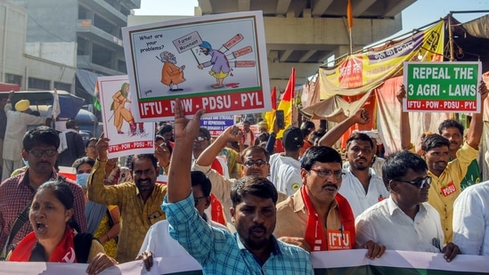 Farmers hold placards as they protest against the three farm laws at Tikri border in New Delhi on Tuesday. (ANI photo) Farmers hold placards as they protest against the three farm laws at Tikri border in New Delhi on Tuesday. (ANI photo)