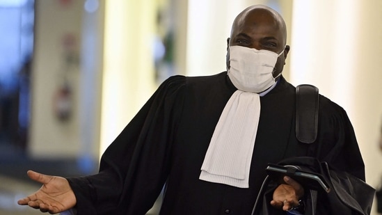 Lawyer Dieudonne Ilunga Kabinga gestures as he arrives to attend a council chamber's session on the terrorist attacks of November 2015 in Paris - also known as the 'Paris bis' case - at the 'Justitia' site in Evere, in Brussels,(AFP)