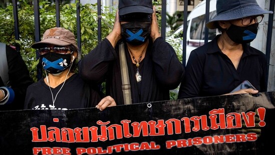 Protesters display a banner outside the Criminal Court in Bangkok on February 24, 2021, during a demonstration calling for the release of pro-democracy activists held under Thailand's lese-majeste royal defamation laws. (Photo by Jack TAYLOR / AFP)(AFP)