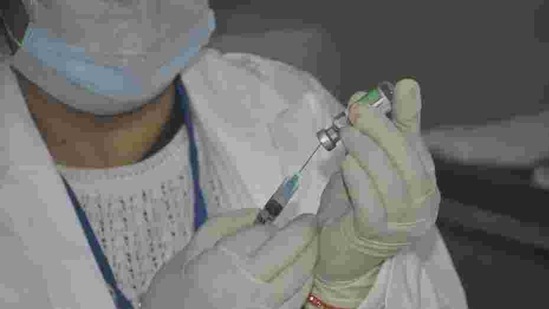 A medic prepares a dose of Covid-19 vaccine(HT file)