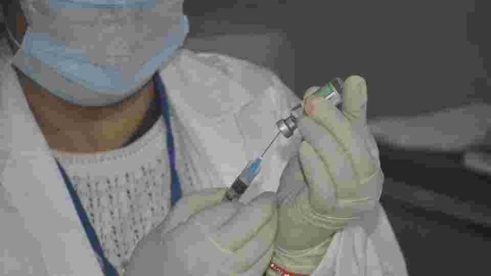 A medic prepares a dose of Covid-19 vaccine to administer to a frontline worker at a health centre on January 16. (HT file) A medic prepares a dose of Covid-19 vaccine to administer to a frontline worker at a health centre on January 16. (HT file)