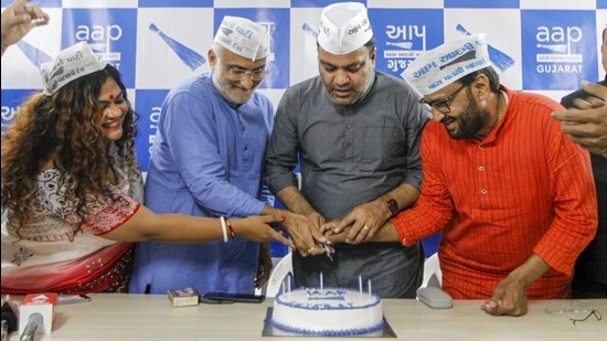 Aam Aadmi Party (AAP) candidate Gulabsinh Yadav along with supporters cuts a cake at an event after emerging victorious during Gujarat Municipal Corporation polls, in Ahmedabad, Tuesday. (PTI)