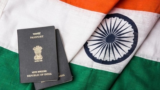 Indian passport and authentic indian tricolour flag made up of khadi or pure cotton material - Stock image(HT Archive)