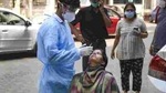 A health worker takes a sample from a woman for Covid-19 test (PTI) A health worker takes a sample from a woman for Covid-19 test (PTI)