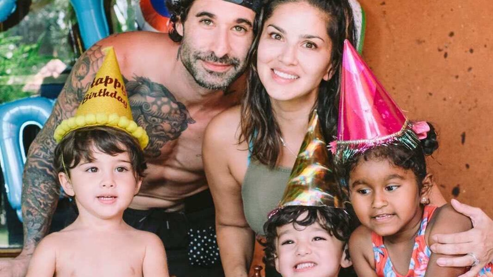 Sunny Leone patiently waits for her turn as Daniel showers their children with kisses at airport. Watch