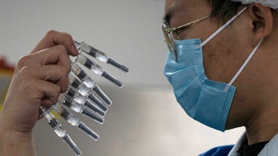 FILE - In this Sept. 24, 2020, file photo, a worker inspects syringes of a vaccine for COVID-19 produced by Sinovac at its factory in Beijing. China approved two new more COVID-19 vaccines for wider use Thursday, adding to its growing arsenal of shots: one from CanSino Biologics, and a second one from state-owned Sinopharm. (AP Photo/Ng Han Guan, File)(AP)