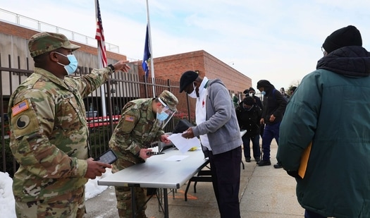 National Guard soldiers help to sign up people for their vaccination appointment at the York College coronavirus (COVID-19) vaccination site on February 24, 2021 in the Jamaica neighborhood of Queens borough in New York City.(AFP)