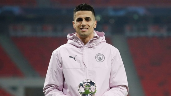 Manchester City's Joao Cancelo poses with his player of the match award.(REUTERS)