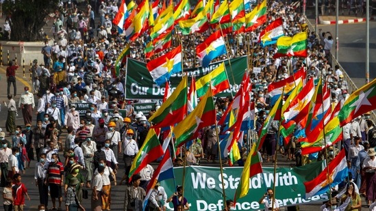 Supporters of Myanmar’s military carry banners and flags during a rally in Yangon on February 25. Hundreds of supporters of the military marched through Yangon carrying signs that said "We stand with Defence Services."(REUTERS)
