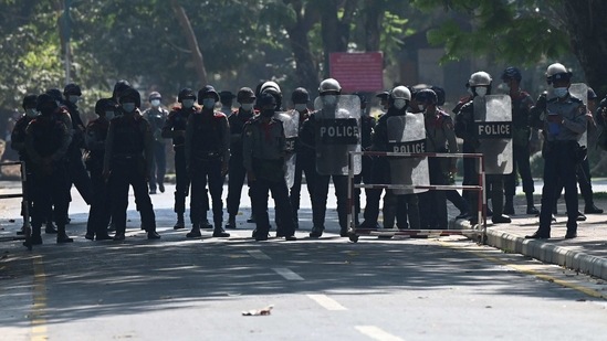 Police block a road during a protest at the Yangon University compound during a demonstration against the military coup in Yangon on February 25. Authorities granted junta supporters access to Yangon's Sule Pagoda, a local landmark at a key junction that in recent days was barricaded to prevent anti-coup protesters from amassing, AFP reported.(Ye Aung THU / AFP)