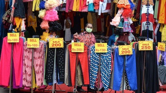 A vendor selling clothes waits for customers at a market in Hyderabad on November 27, 2020(AFP/For Representational Purposes Only) A vendor selling clothes waits for customers at a market in Hyderabad on November 27, 2020(AFP/For Representational Purposes Only)