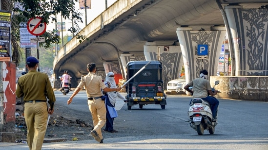 Police in Amravati stop commuters after a restriction was imposed due to an increase in Covid-19 cases on Wednesday.(PTI)