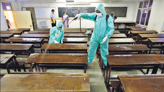 Workers sanitise a classroom at SIES College in Sion, Mumbai. (HT FILE) Workers sanitise a classroom at SIES College in Sion, Mumbai. (HT FILE)