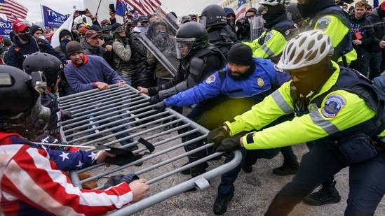 FILE - In this Jan. 6, 2021, file photo rioters try to break through a police barrier at the Capitol in Washington. Congress is set to hear from former security officials about what went wrong at the U.S. Capitol on Jan. 6. That's when when a violent mob laid siege to the Capitol and interrupted the counting of electoral votes. Three of the four testifying Tuesday resigned under pressure immediately after the attack, including the former head of the Capitol Police. Much is still unknown about the attack, and lawmakers are demanding answers. (AP Photo/John Minchillo, File)(AP)