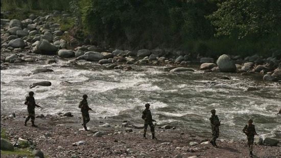 BSF soldiers patrol next to a stream near the LoC, at Sabjiyan sector of Poonch district. (HT archive)