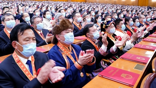 In this photo released by China's Xinhua News Agency, attendees applaud during a ceremony to mark the official end of extreme poverty in China held at the Great Hall of the People in Beijing,(AP) In this photo released by China's Xinhua News Agency, attendees applaud during a ceremony to mark the official end of extreme poverty in China held at the Great Hall of the People in Beijing,(AP)