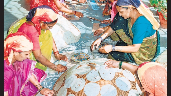 At Lijjat, members roll dough on special platforms for uniformly sized papads. The co-operative sells more than 4 billion of them a year.