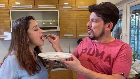 Dr Shriram Nene feeding Madhuri Dixit a slice of homemade pizza.