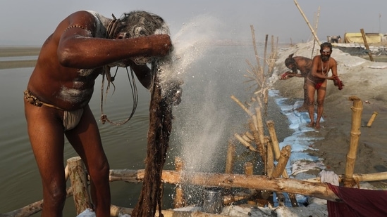 A Holy man smears ash on his hair after a holy dip at Sangam, the sacred confluence of the rivers Ganga, Yamuna and the mythical Saraswati, during Magh Mela festival, in Prayagraj, India Tuesday, Feb. 16, 2021.(AP)