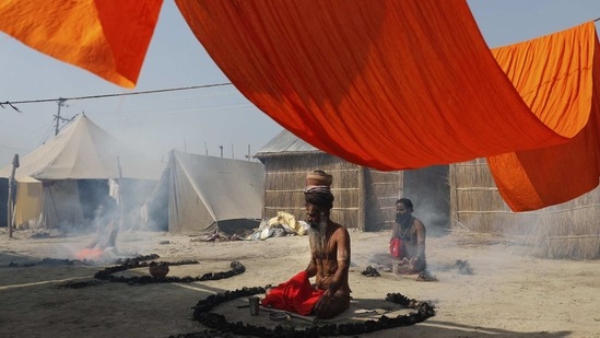 Holy men pray on the banks of the river Ganges during Magh Mela festival, in Prayagraj, India Tuesday, Feb. 16, 2021.(AP)